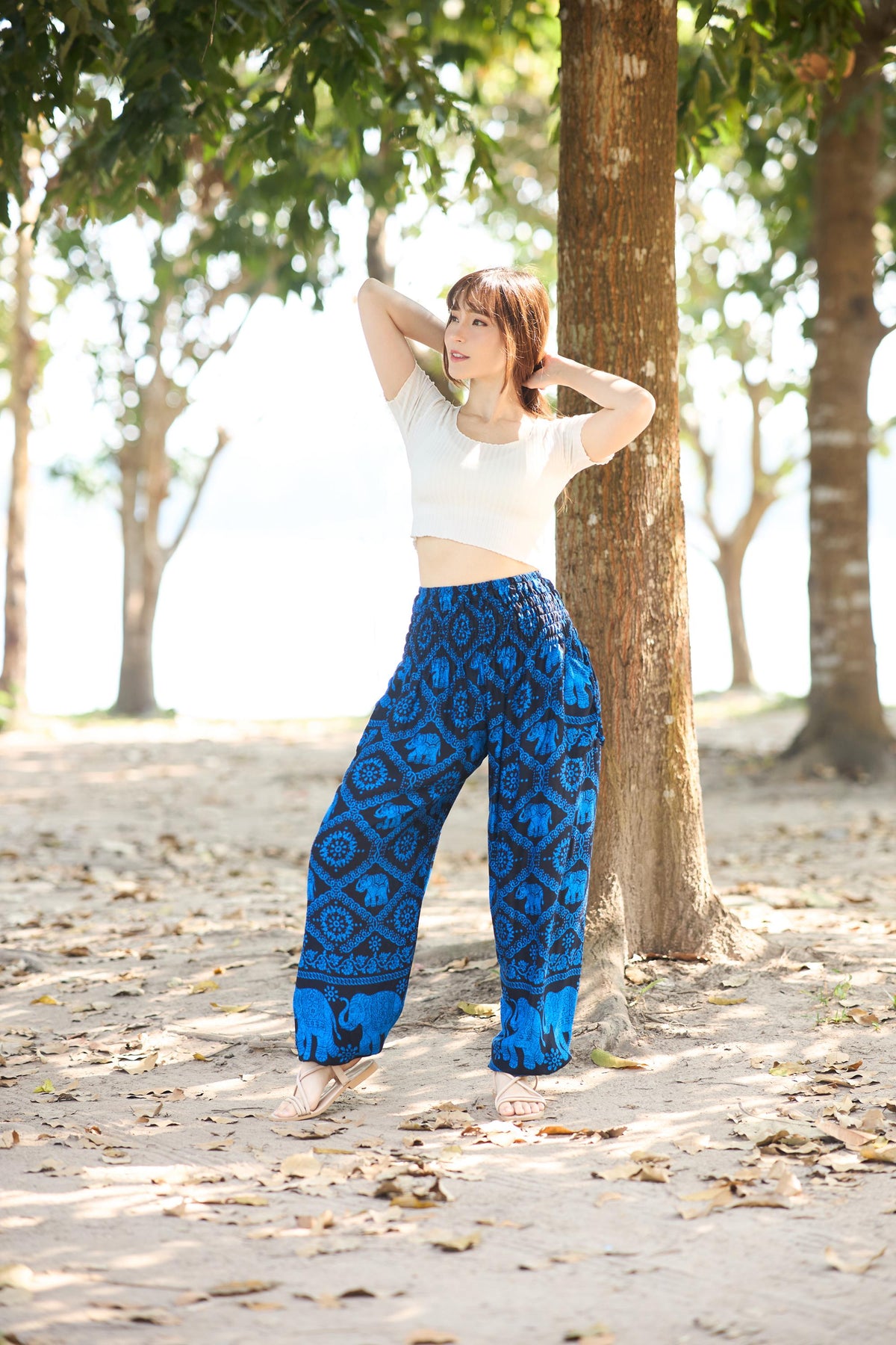 Women's black and blue elephant print harem pants with smocked waist and two pockets