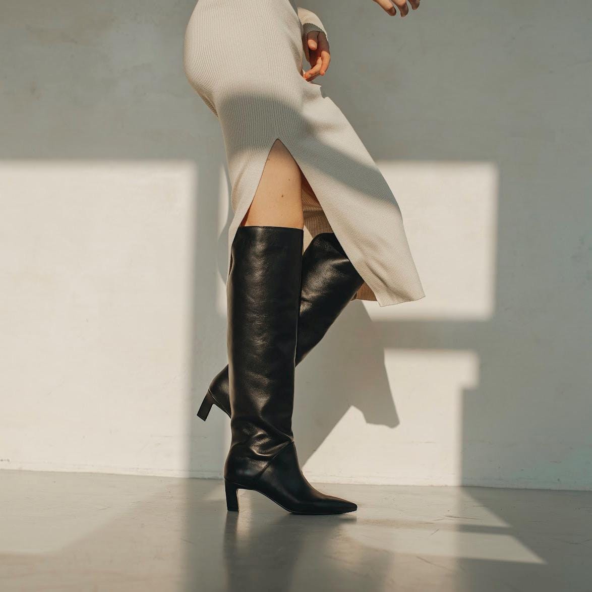Made-to-measure black leather over-the-knee boots with wool lining