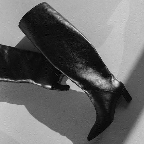 Black leather knee boots with cushioned insole and tunit sole