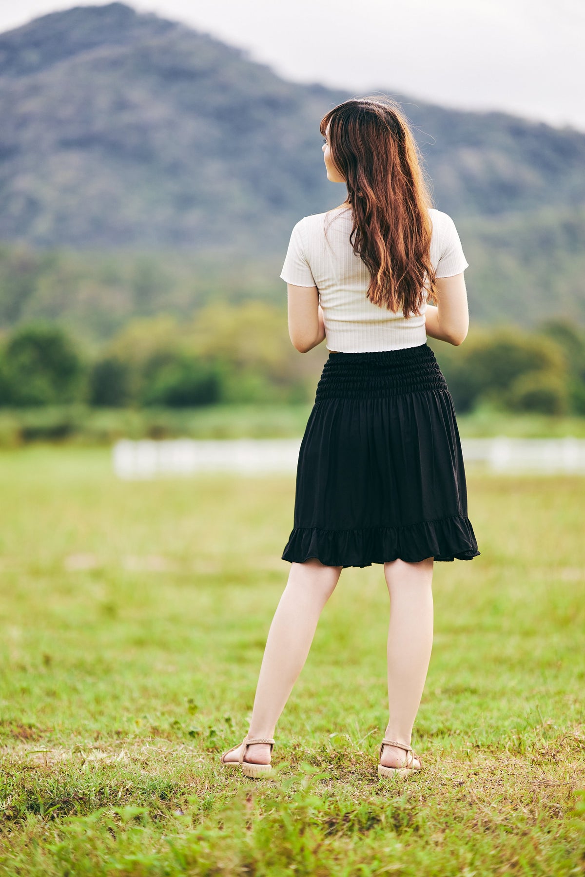Short black boho skirt with smocked waist and soft rayon fabric
