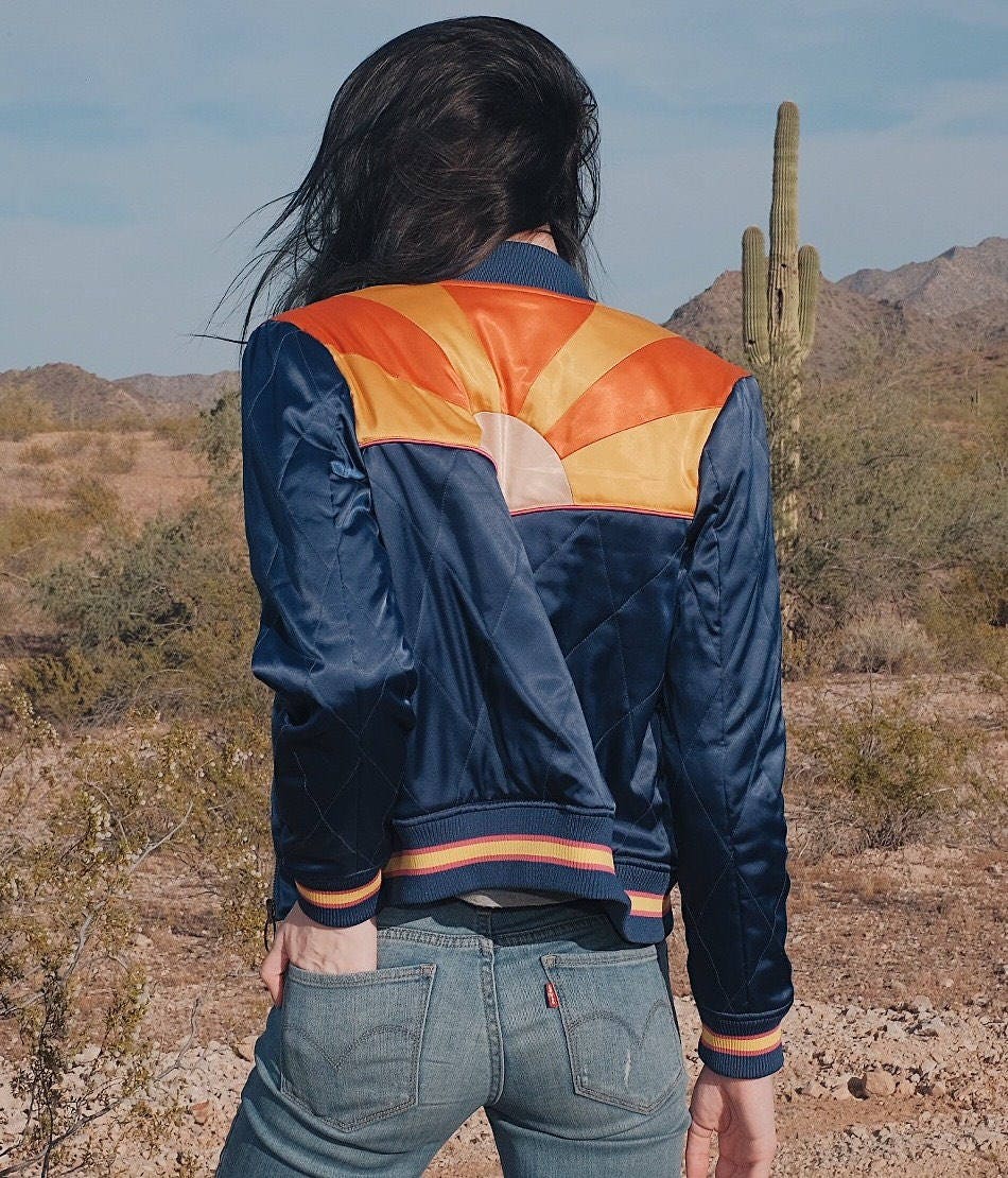 Sonoran Sunrise unisex bomber jacket in matte black brown with rust maroon and yellow stripes