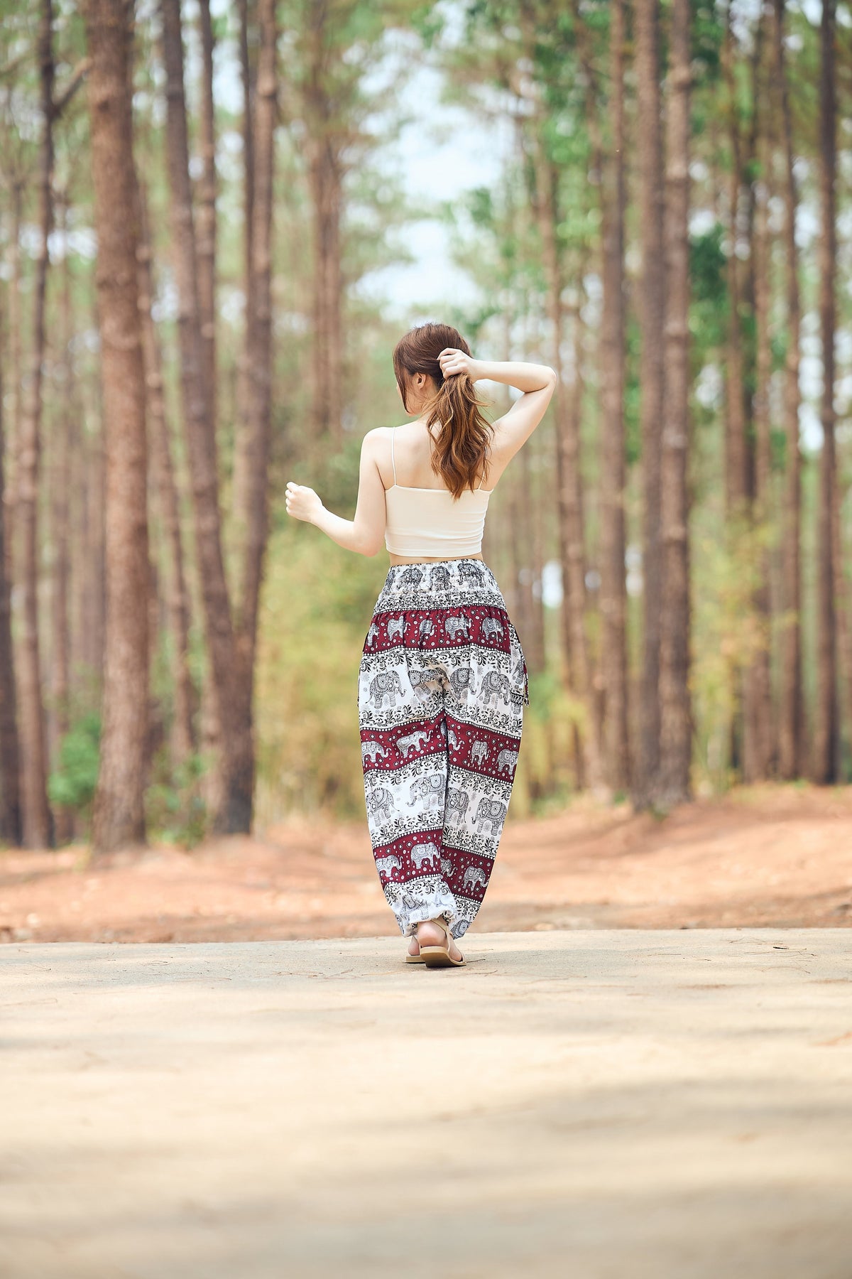 Front view of ivory burgundy elephant print harem pants for women, soft rayon fabric