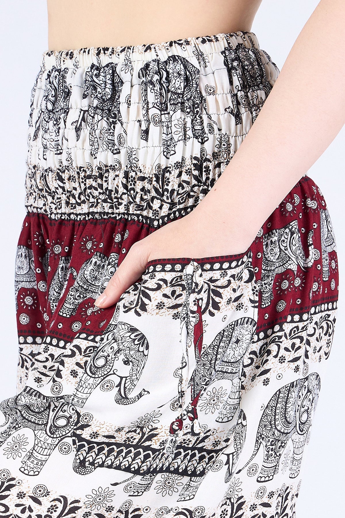 Close-up of ivory burgundy elephant harem pants showing soft rayon texture and pockets