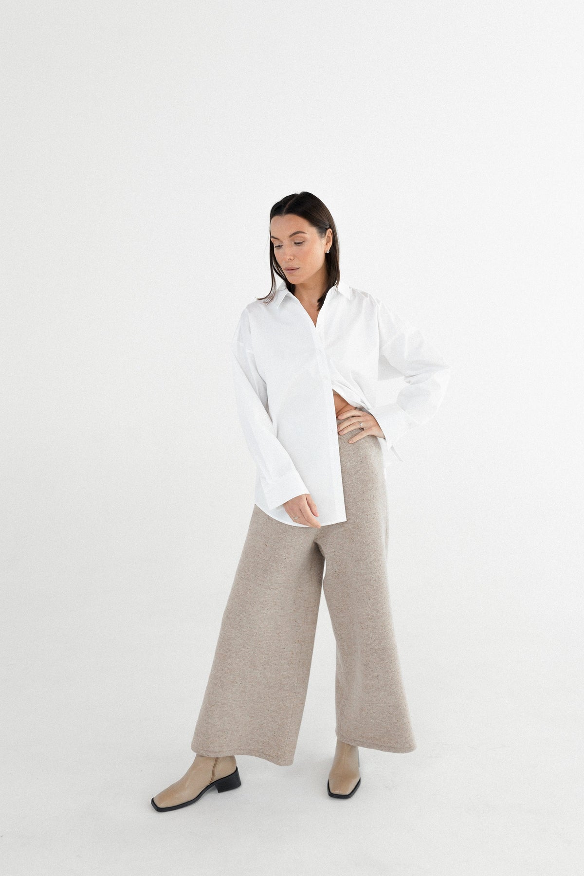 High waist wool palazzo pants in beige on model with dark hair