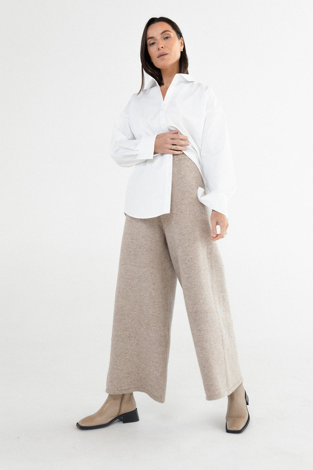 Light gray wide-leg trousers on model with red hair