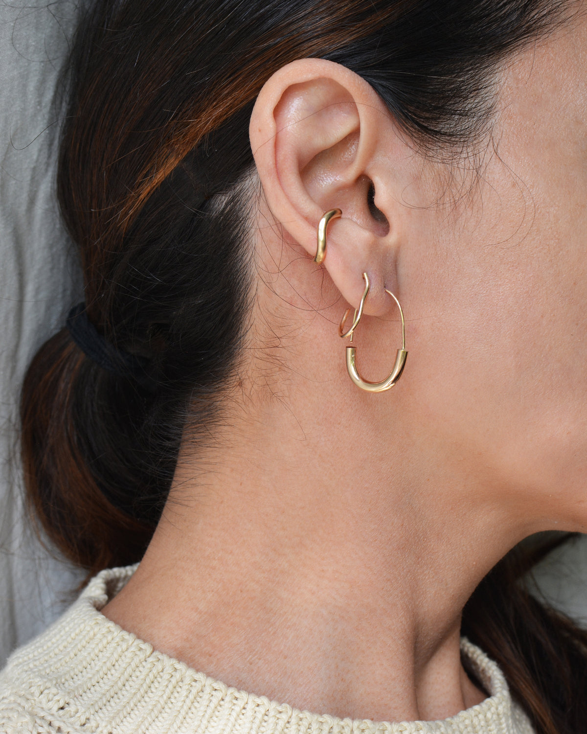 14k gold filled wavy ear cuff shown on ear with Sona Hoops