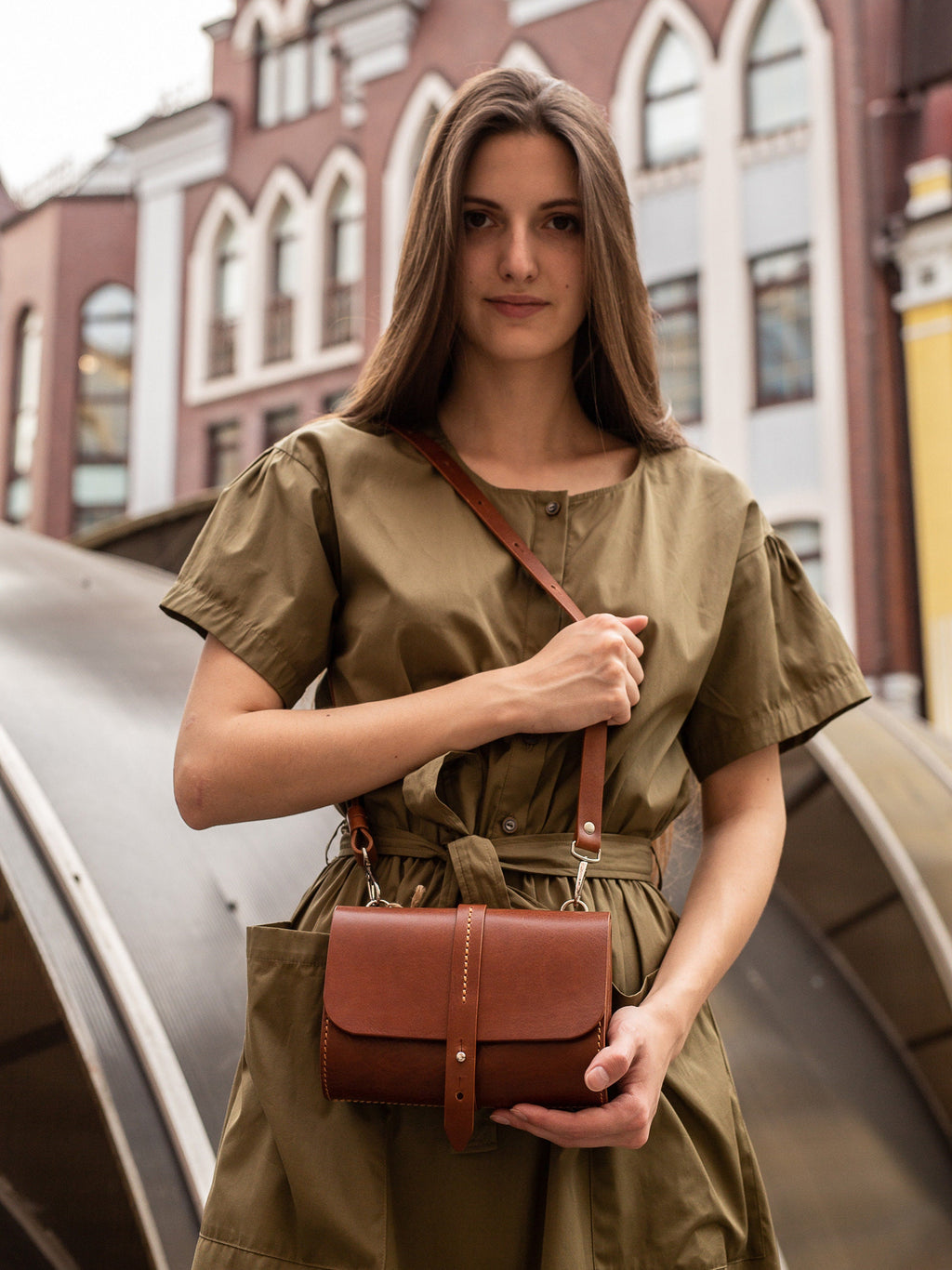 Convertible leather waist bag styled as an evening clutch purse