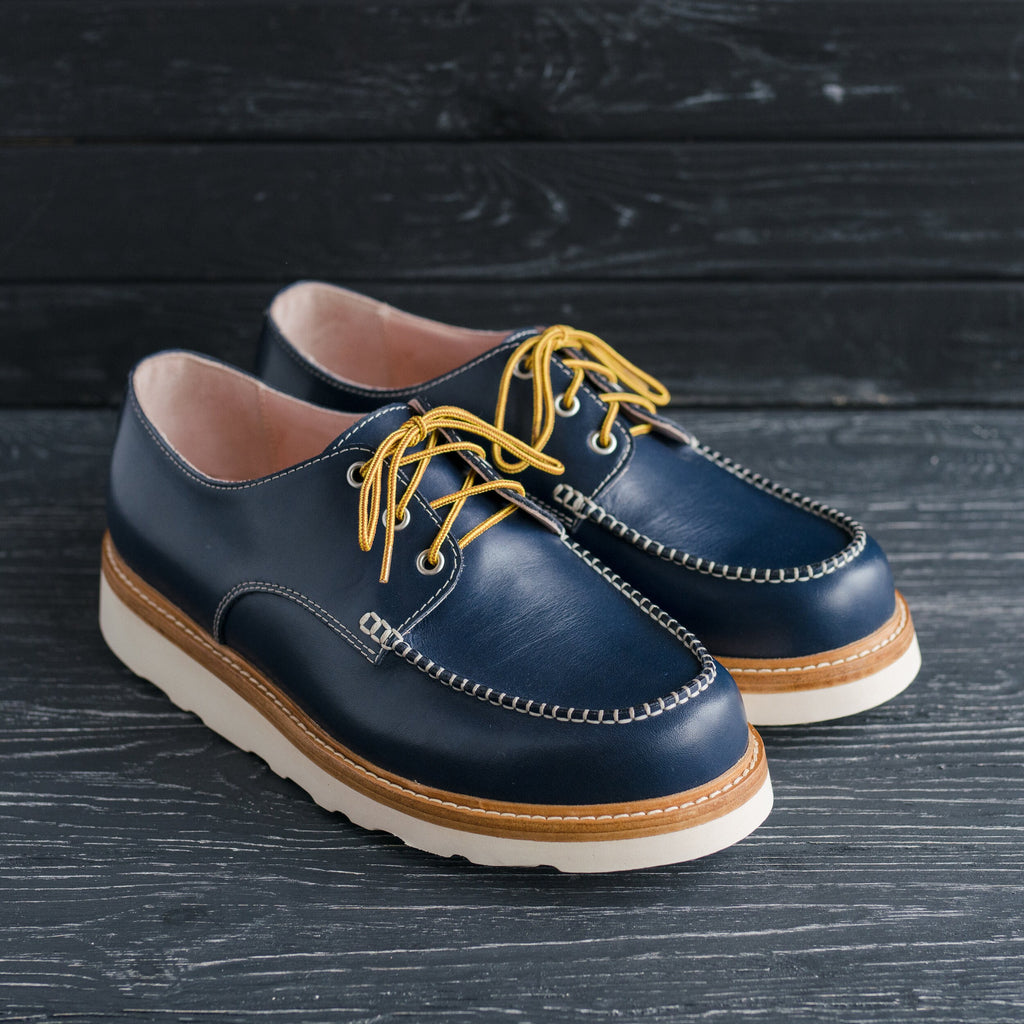Hand sewn moccasin stitch orange leather boots with Vibram Cristy wedge sole
