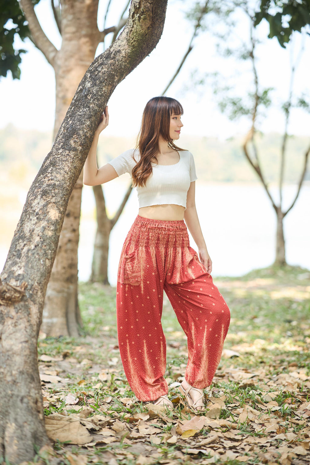 Orange peacock feather harem pants for women with smocked waist and side pockets