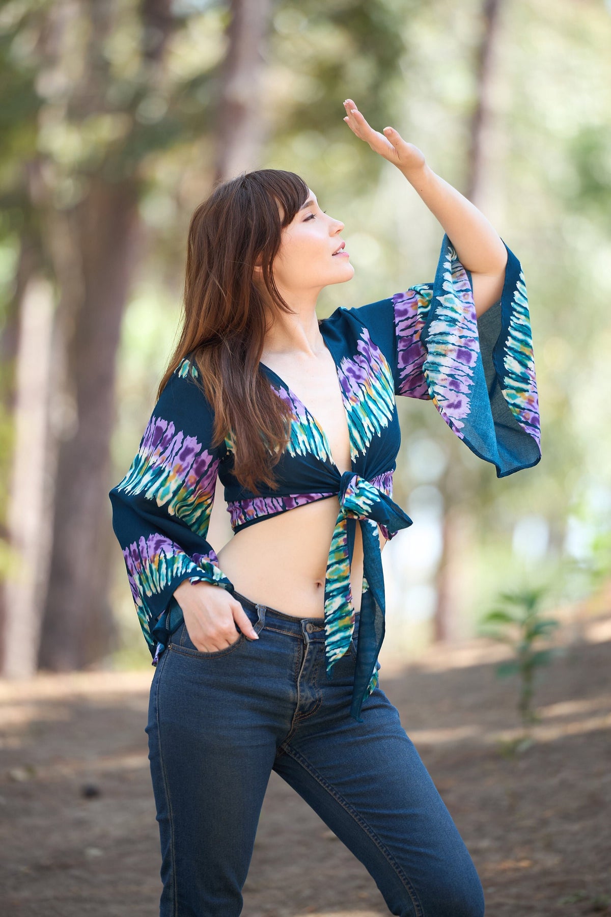 Women's rayon wrap top with bell sleeves in colorful teal print