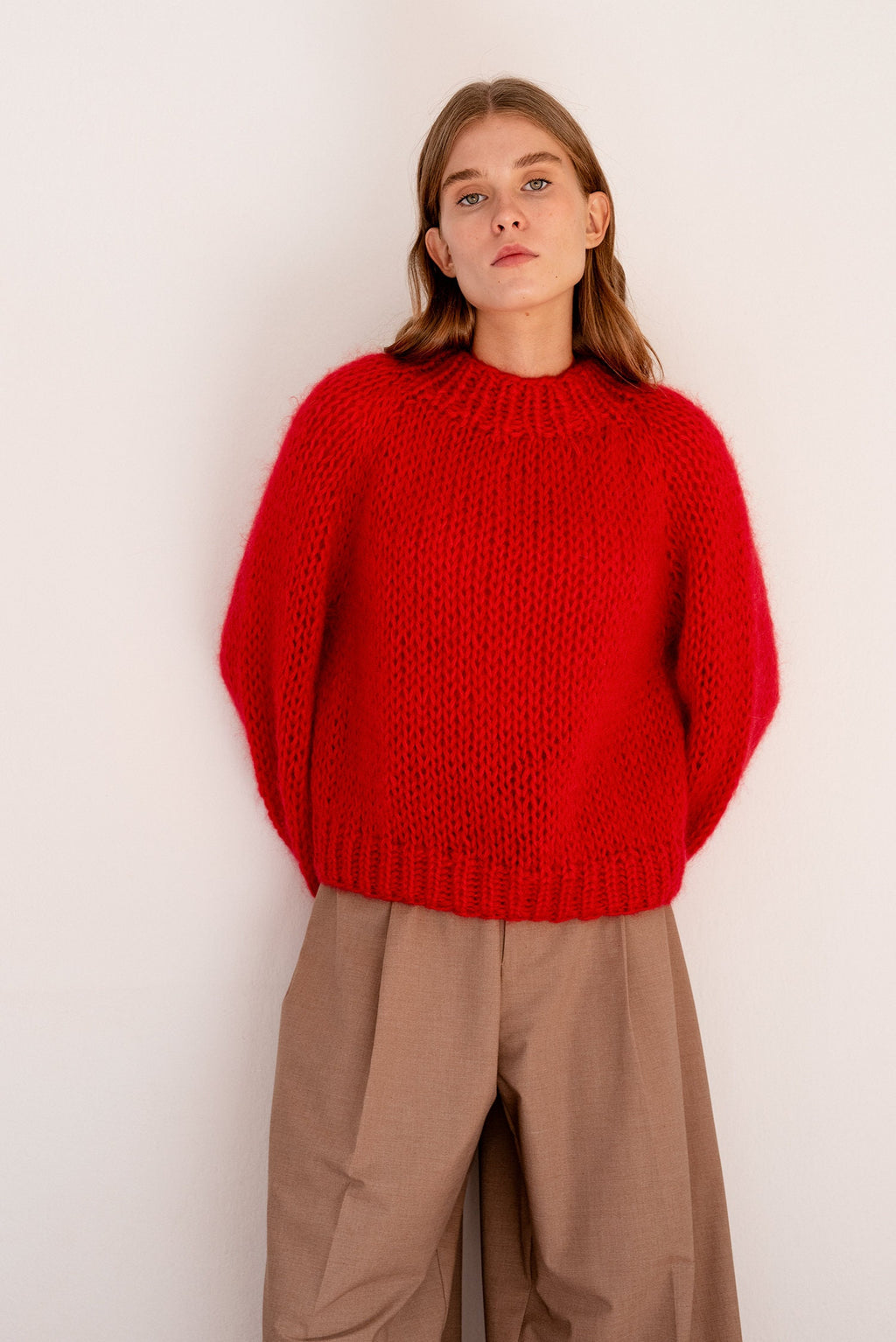 Hand knit lava red sweater with voluminous ribbed mock neck